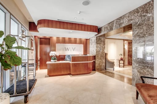 a lobby with a reception desk and a large window