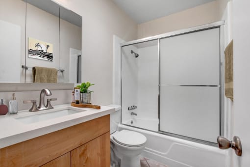 a bathroom with a toilet sink and shower