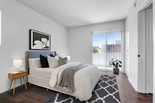 a bedroom with a large bed and a large window