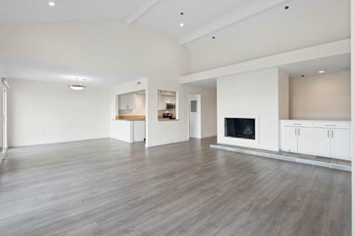A spacious living room with a fireplace and a television.