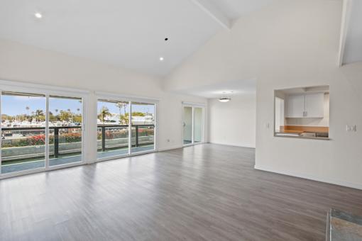 A spacious room with a view of the outdoors through large windows.