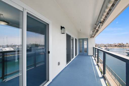 A balcony with a view of the water and boats.