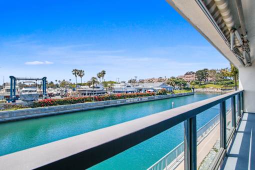 A view of a river from a bridge with a clear blue sky.