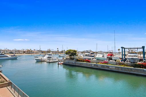 A marina with boats docked and a clear blue sky.