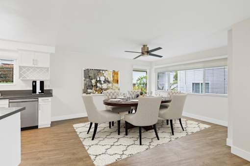 A modern dining room with a table set for four.