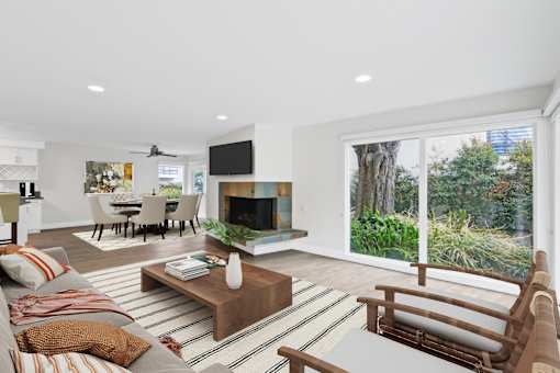 A living room with a fireplace and a television.