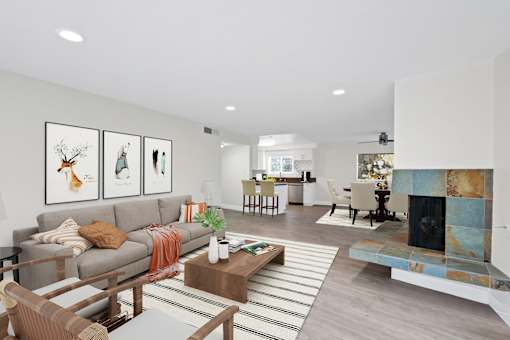 A living room with a grey couch and a coffee table.