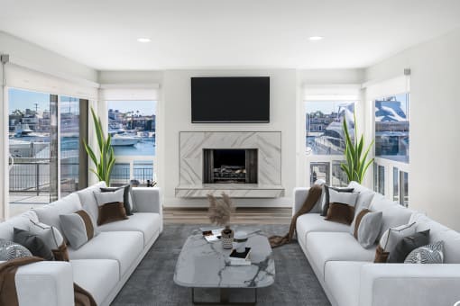 a living room with white couches and a fireplace