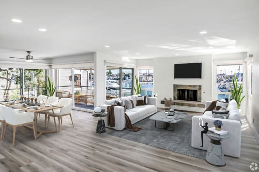 a spacious living room with a fireplace and a patio