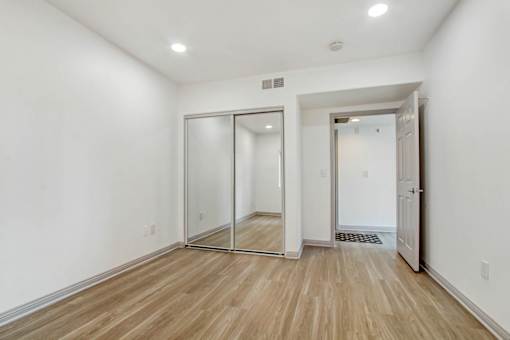 A room with a white wall and a wooden floor.