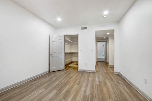 A room with a white door and a white wall.