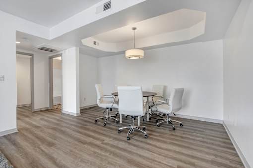 A conference room with a table and chairs.