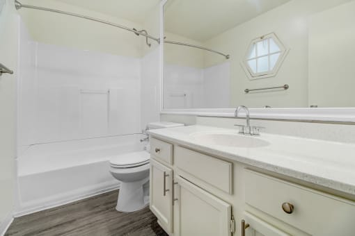 a bathroom with a sink toilet and a bath tub