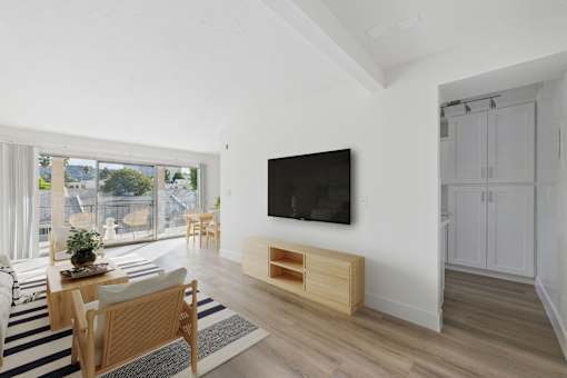 A modern living room with a flat screen TV mounted on the wall.