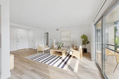 A living room with a white couch and a coffee table.