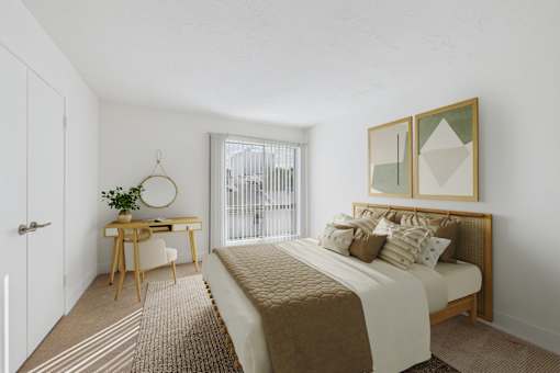 A bedroom with a bed, desk, and chair.