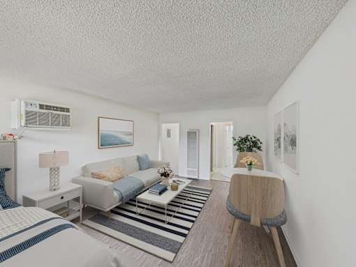 A living room with a grey couch and a striped rug.
