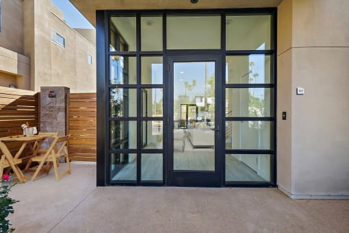a patio with glass doors and a table and chairs