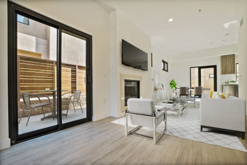 a living room with a fireplace and sliding glass doors