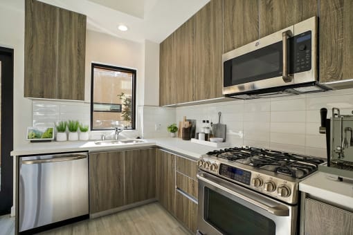 a kitchen with stainless steel appliances and wooden cabinets