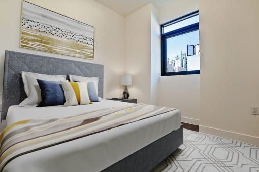 a bedroom with a large bed and a window