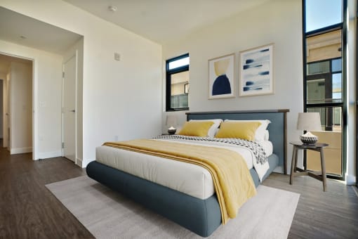 a bedroom with a bed and a large window