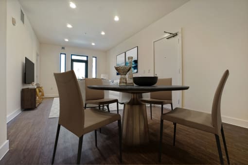 a dining room with a table and chairs and a tv