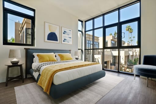 a bedroom with a bed and a large window