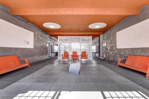 a long corridor with gray walls and an orange ceiling