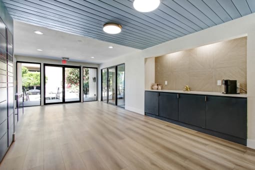a lobby with a blue ceiling and wood flooring