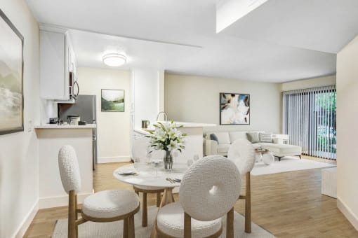 a living room and dining room with a table and chairs