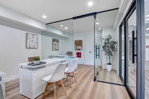 a dining area with a table and chairs and a sliding glass door