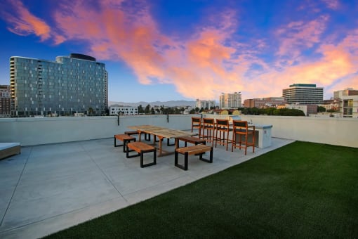 a rendering of a park with a city in the background