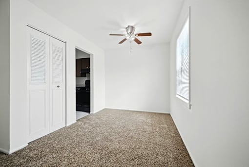 Dining area with carpeted floor and natural light in 2-bedroom Ashton Pointe apartment.