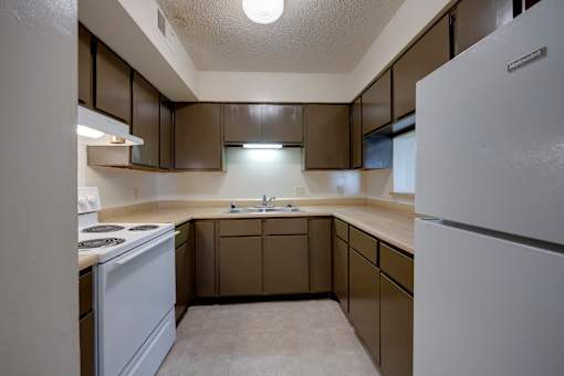 Kitchen with all white appliances and ample cabinets in a 3 bedroom apartment at Regency Park Apartments