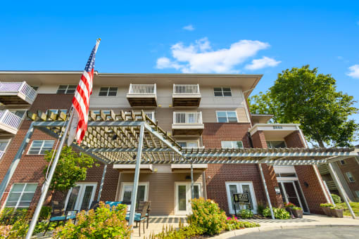 Exterior view of the apartment building at Arden Woods, showcasing well-maintained landscaping, and inviting entrances.