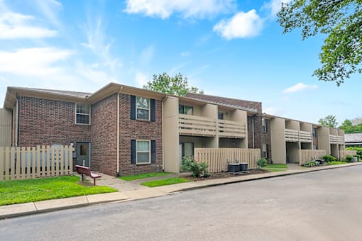 Exterior of an apartment building at Fairington of Louisville with balconies and patios.