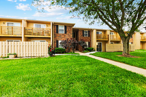 Exterior view of an apartment building at Fairington Apartments in Columbus, Indiana, showcasing brick architecture and landscaped grounds.