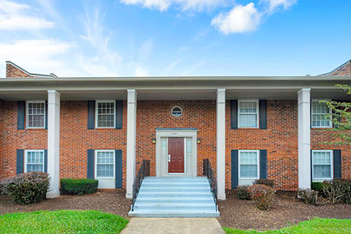 Exterior of an apartment building at Mount Vernon, showcasing large windows, and surrounding landscaping.