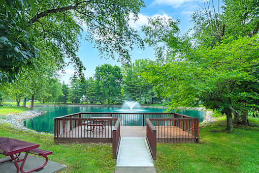 Serene pond at Fairington of Louisville, surrounded by lush greenery and offering a tranquil outdoor setting.