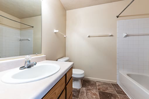 Bathroom with a sink, toilet, and bathtub in a two-bedroom, two-bath apartment at North Lake Apartments.