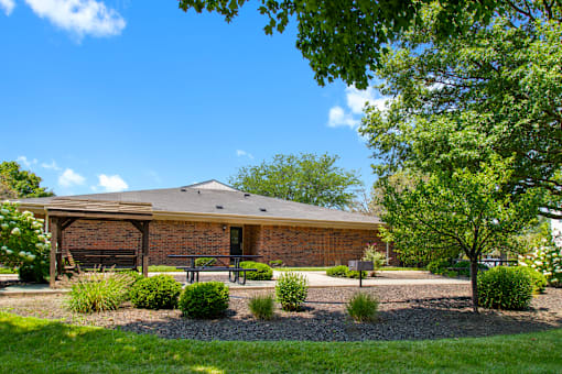 BBQ and picnic area at Fairington Apartments in Lafayette, featuring grills, picnic tables, and a landscaped outdoor space.