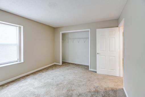 Bedroom with a  closet in a 2-bedroom, 1-bath apartment at Hampton Place Apartments, offering storage and shelving.