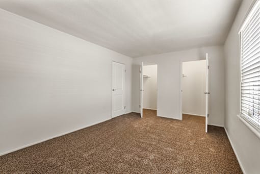 Spacious bedroom with closets in a 1-bed, 1-bath apartment at Bradford Lake Apartments.
