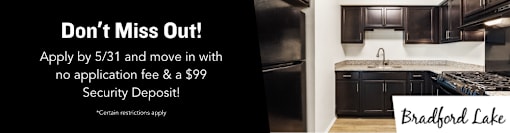 A modern kitchen with a sign offering a $99 security deposit for moving in.