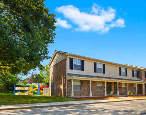Exterior view of Cambridge Square Apartments in Greenwood, showcasing landscaped grounds.