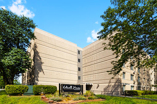 Exterior view of Edsall House in Fort Wayne, featuring a monument sign in front of the apartment complex and the building in the background.