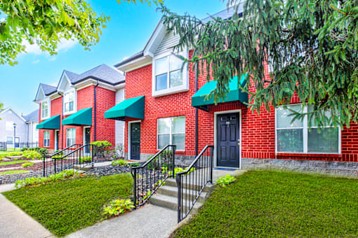 Exterior view of the building at Hampton Place Apartments, showcasing architecture and well-maintained landscaping.