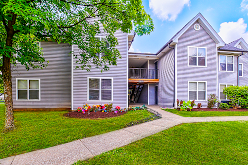 Exterior view of the building at Hampton Place Apartments, showcasing architecture and well-maintained landscaping.