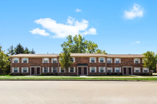 Exterior of Richfield Apartments in Fort Wayne, featuring lush landscaping, and a welcoming entrance.